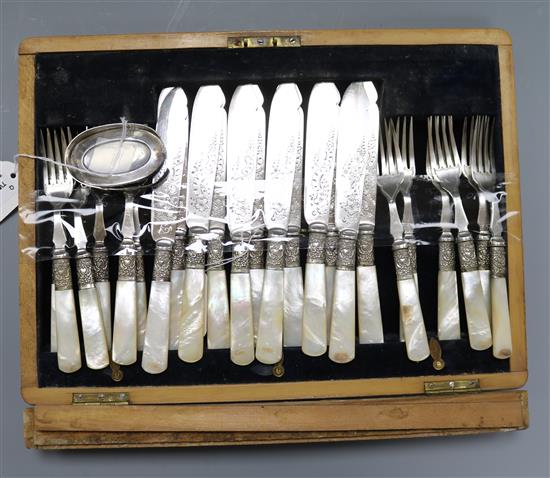 A set of twelve pairs of mother of pearl-handled plated fish eaters (canteen a.f.) and a silver toilet jar top
